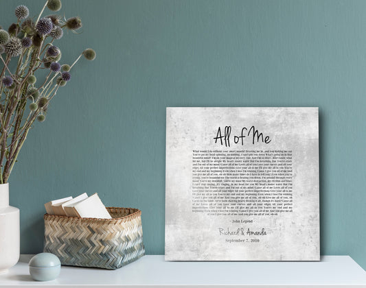 This is a  square custom song sign or plaque produced on distressed, tarnished Tin in rustic silver and gray tones. Wedding song lyrics are inscribed on the face and in a casual script, the names of the happy couple, followed by their union date.